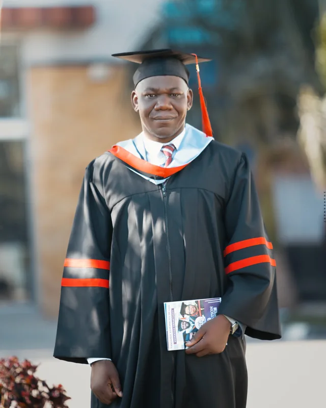 Rev. Thomas Simion pictured in academic regalia.